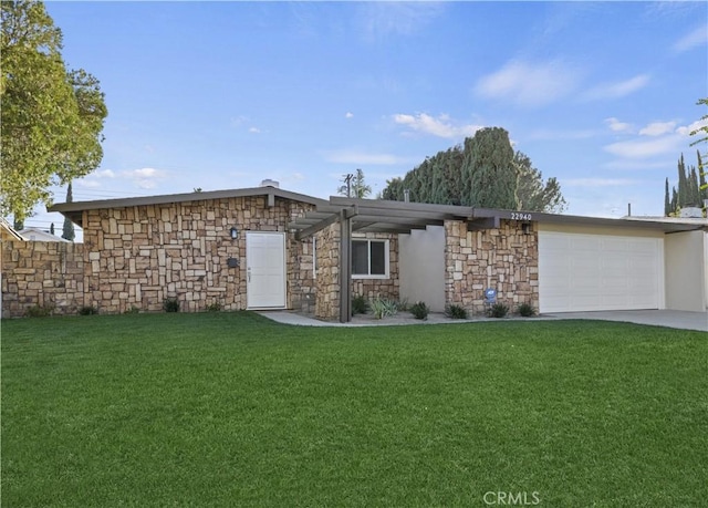 ranch-style home with a garage and a front lawn