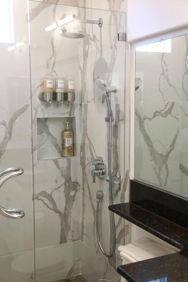 bathroom featuring a shower with door