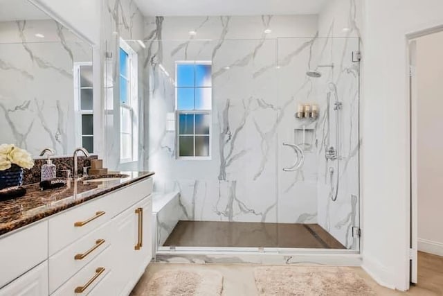 bathroom with vanity and a shower with shower door