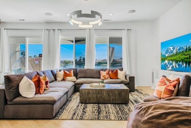 living room with a water view and light wood-type flooring