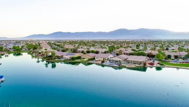 drone / aerial view with a water and mountain view