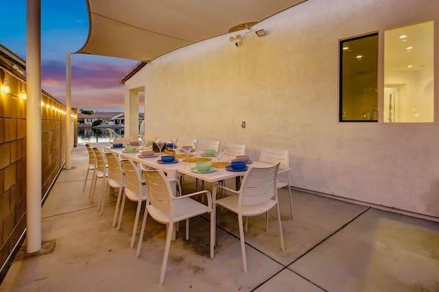 view of patio terrace at dusk