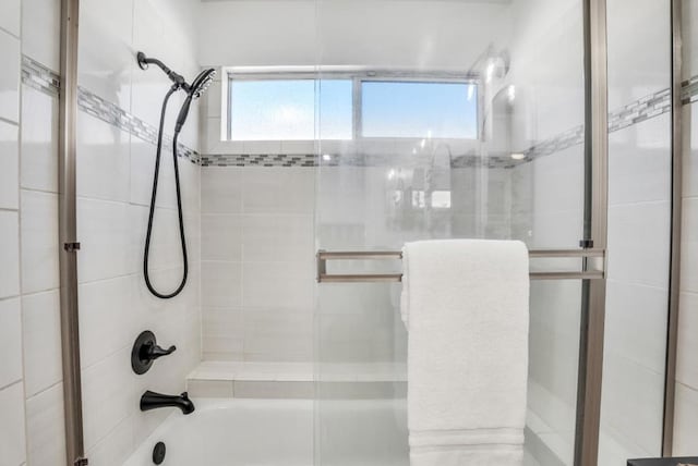 bathroom with shower / bath combination with glass door