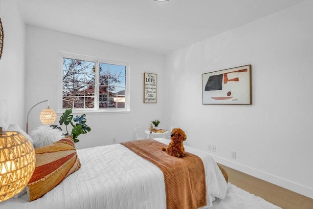 bedroom with hardwood / wood-style flooring