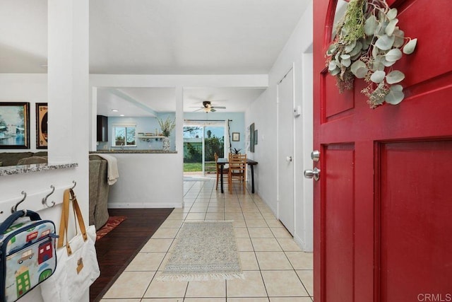 tiled foyer featuring ceiling fan