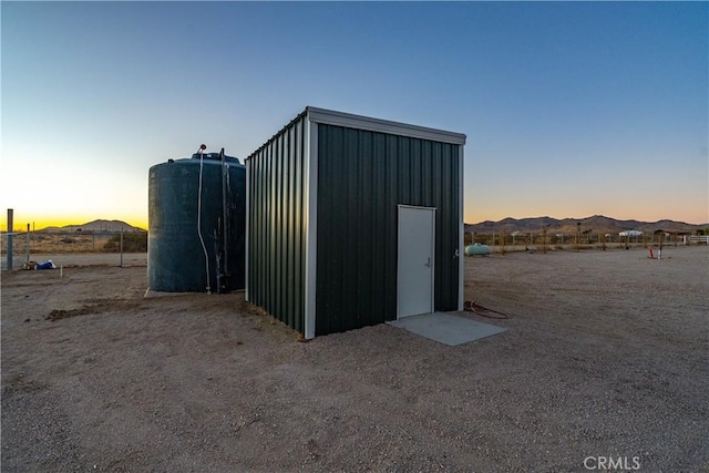 outdoor structure at dusk featuring a mountain view