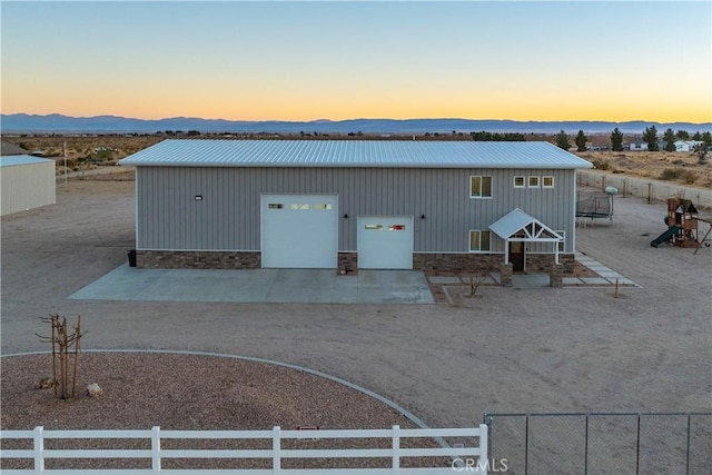 exterior space featuring a garage and a mountain view