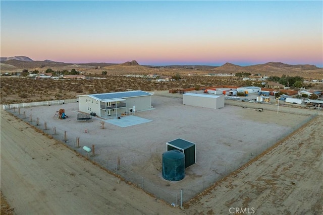 aerial view at dusk featuring a mountain view