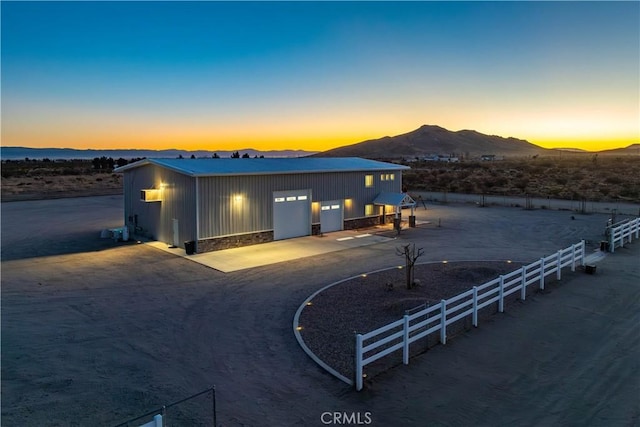 view of front of home featuring a mountain view and an outdoor structure