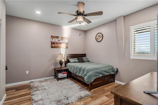 bedroom with ceiling fan and light hardwood / wood-style flooring