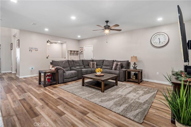 living room with ceiling fan and light hardwood / wood-style floors