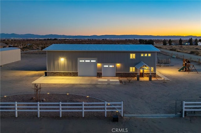 view of front of property featuring a mountain view and an outdoor structure