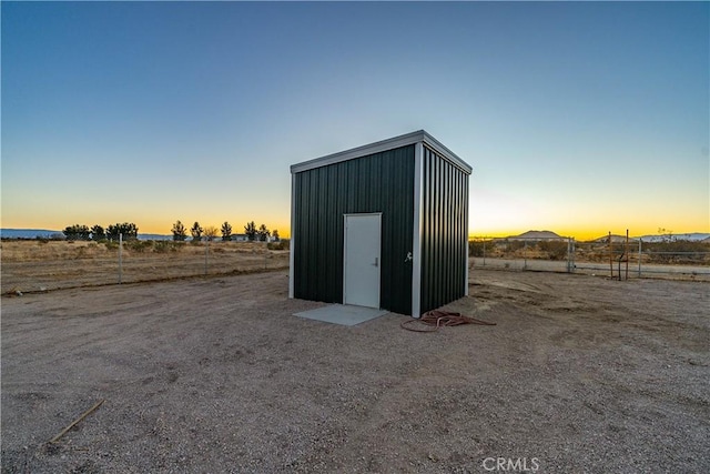 outdoor structure at dusk with a rural view