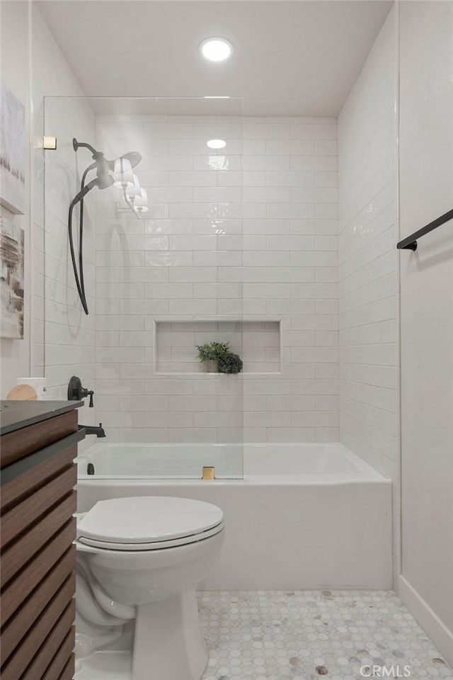 bathroom with tiled shower / bath combo and toilet