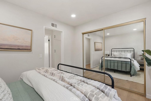 bedroom with a closet and light wood-type flooring