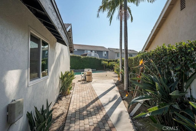 view of patio / terrace with a fenced in pool