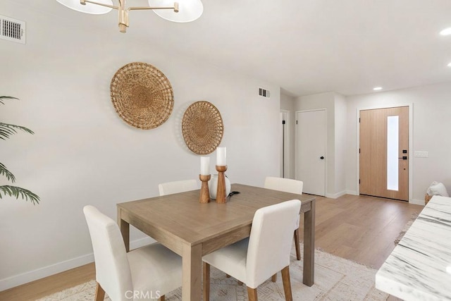 dining space featuring light wood-type flooring