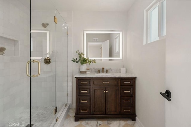 bathroom featuring vanity and an enclosed shower