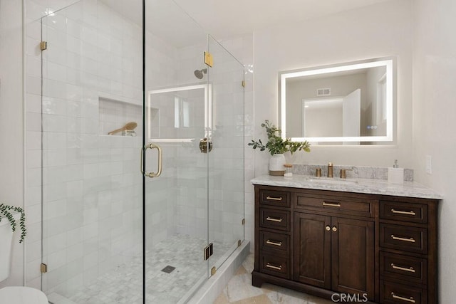 bathroom featuring vanity and an enclosed shower