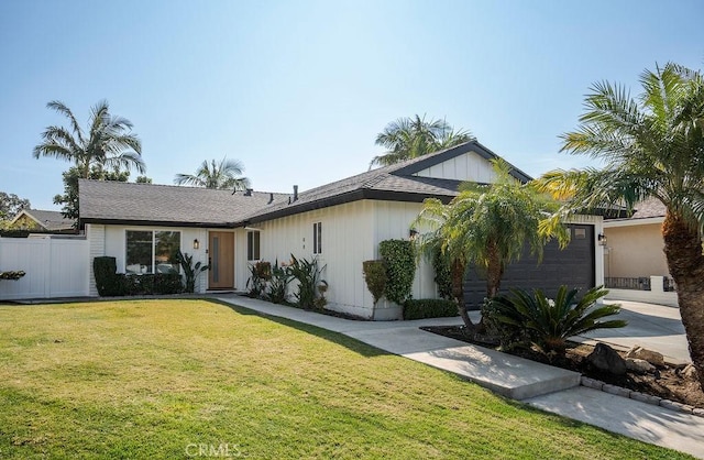 view of front of house with a garage and a front lawn