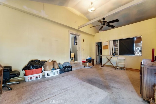 interior space featuring vaulted ceiling, carpet floors, and ceiling fan