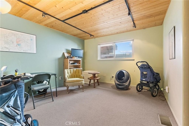 home office with track lighting, wooden ceiling, and carpet