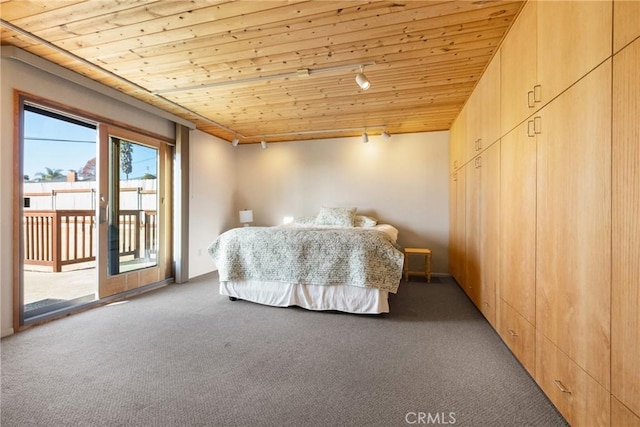 bedroom featuring carpet floors, access to outside, and wooden ceiling