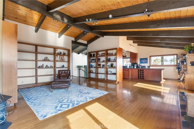 sitting room featuring hardwood / wood-style flooring, rail lighting, high vaulted ceiling, wooden ceiling, and beamed ceiling