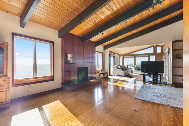 living room with vaulted ceiling with beams, wood ceiling, dark hardwood / wood-style floors, and a water view