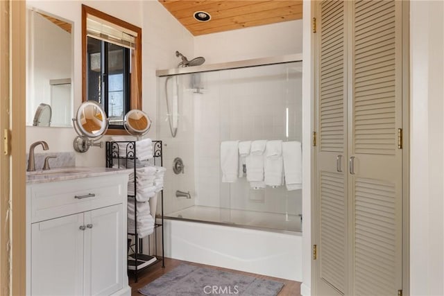 bathroom featuring lofted ceiling, vanity, wood ceiling, and enclosed tub / shower combo