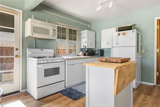 kitchen featuring sink, white cabinets, white appliances, and light hardwood / wood-style flooring