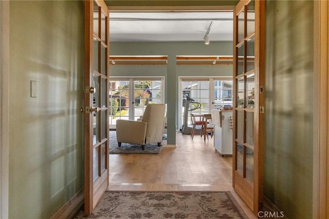 interior space with light hardwood / wood-style floors and french doors