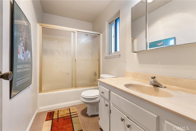 full bathroom with vanity, shower / bath combination with glass door, and toilet