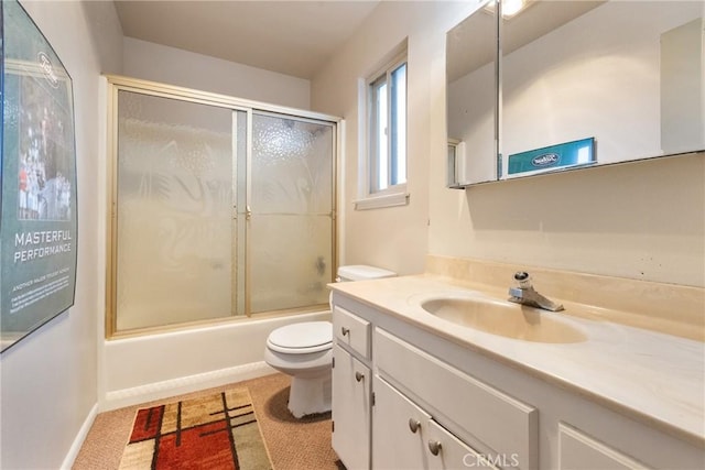 full bathroom featuring vanity, toilet, and combined bath / shower with glass door