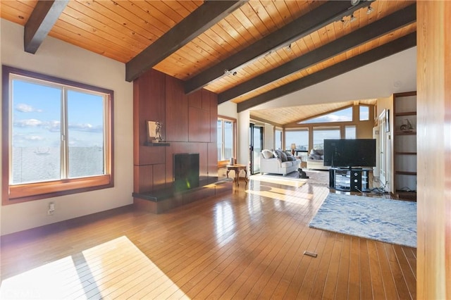 living room with vaulted ceiling with beams, wood ceiling, and light hardwood / wood-style floors