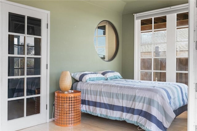 bedroom featuring hardwood / wood-style flooring and vaulted ceiling