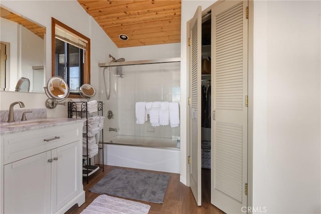 bathroom with wood ceiling, hardwood / wood-style flooring, shower / bath combination with glass door, vanity, and vaulted ceiling