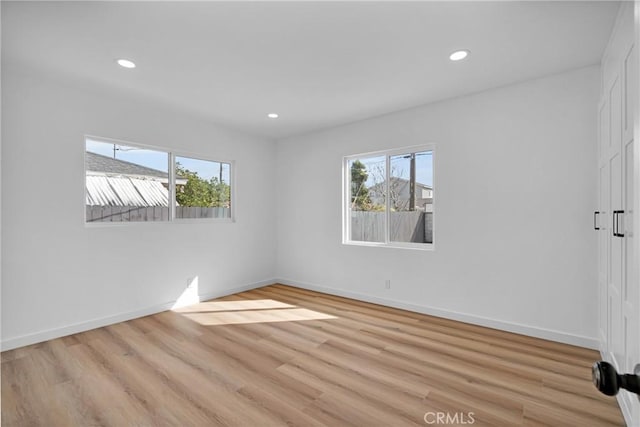 unfurnished room with light wood-type flooring