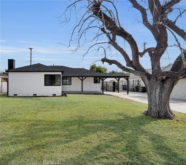 ranch-style house with a carport and a front lawn