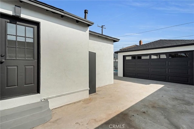 view of side of property featuring an outbuilding and a garage