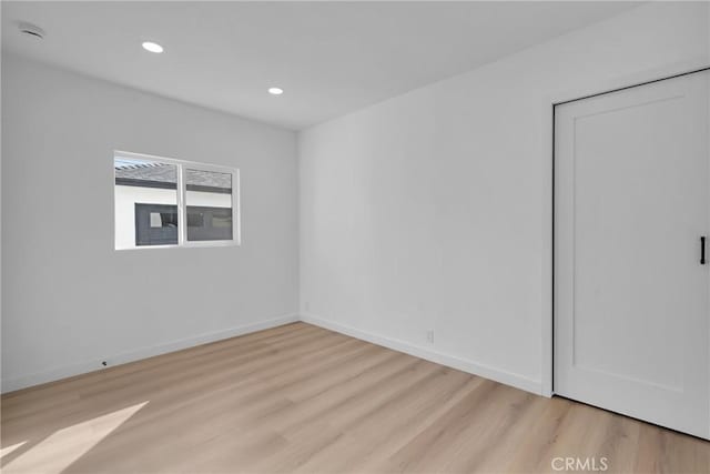 spare room featuring light hardwood / wood-style floors