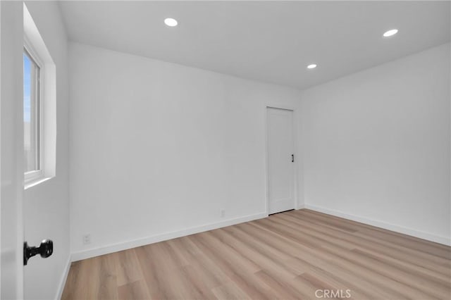 unfurnished room with a wealth of natural light and light hardwood / wood-style floors