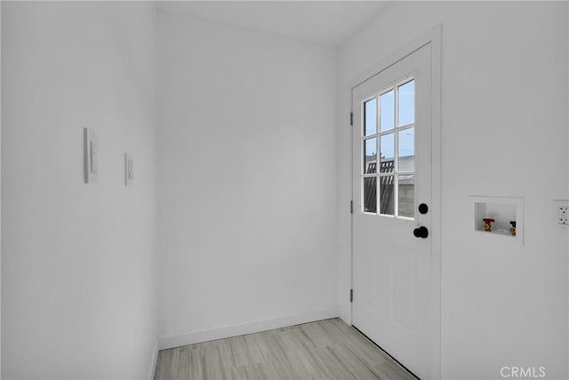 clothes washing area with washer hookup and light hardwood / wood-style floors