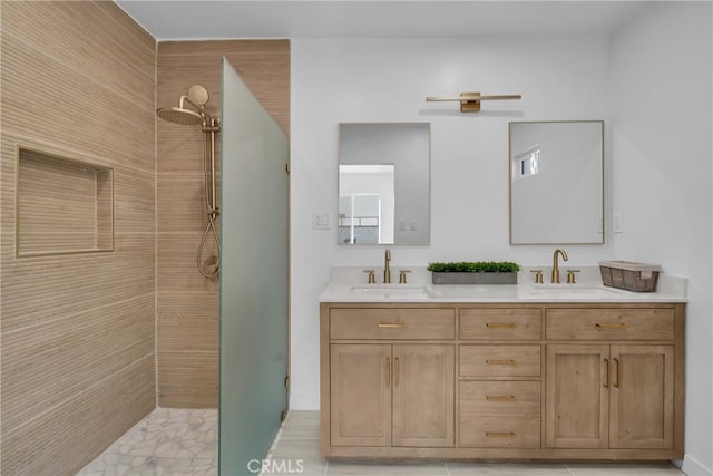 bathroom with vanity, tiled shower, and tile patterned floors