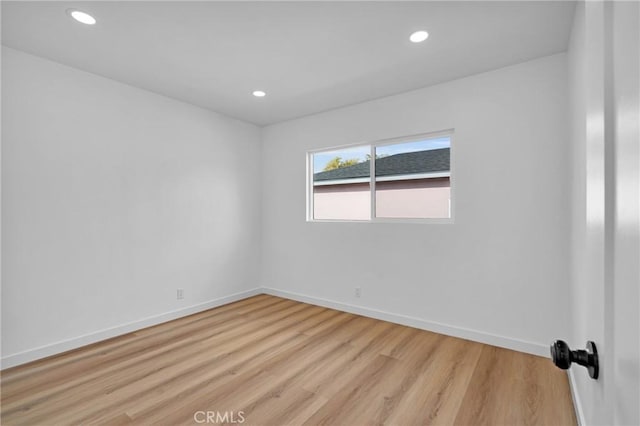 spare room featuring light wood-type flooring