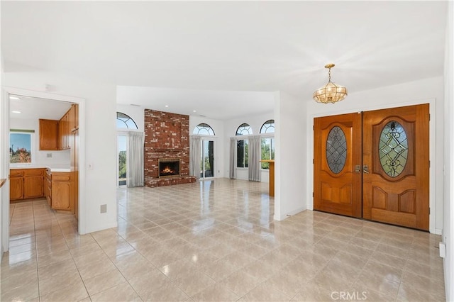 foyer with a fireplace and a chandelier