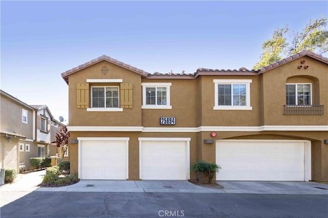 view of front of home with central AC and a garage