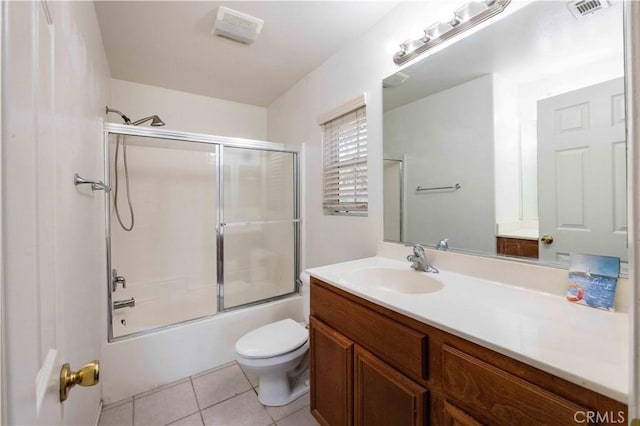 full bathroom featuring bath / shower combo with glass door, vanity, toilet, and tile patterned flooring