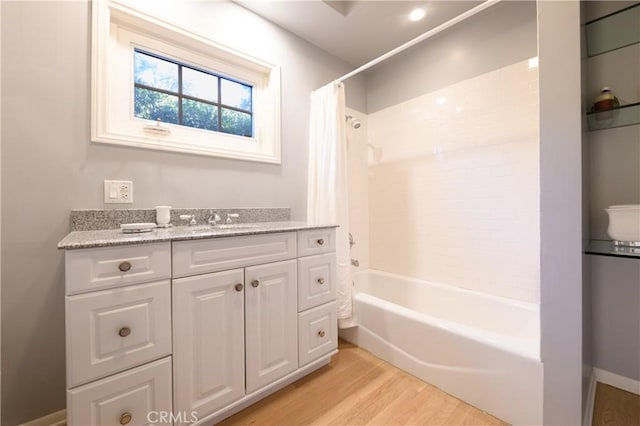 bathroom with vanity, hardwood / wood-style flooring, and shower / tub combo with curtain