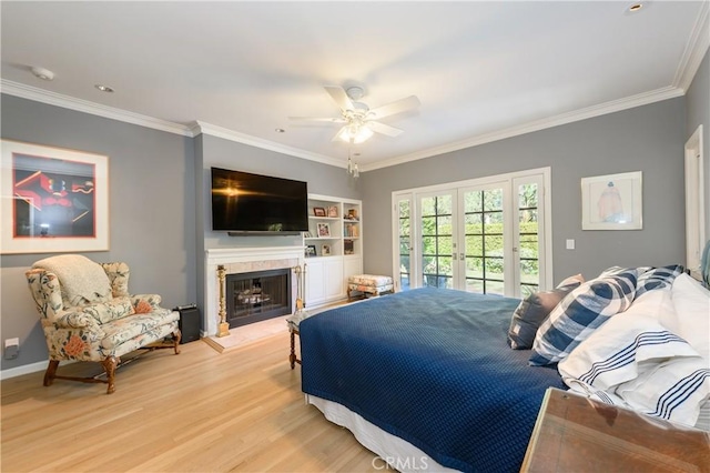 bedroom with crown molding, access to outside, ceiling fan, and light wood-type flooring